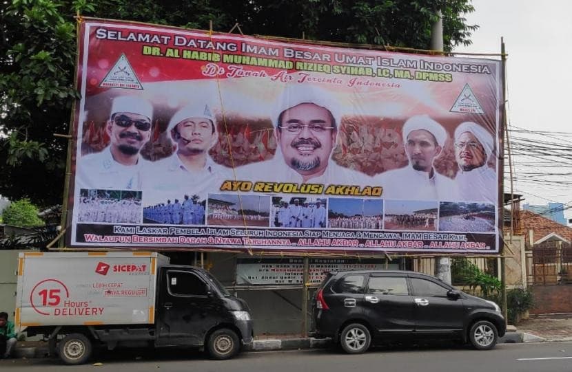 Baliho bergambar Habib Rizieq Shihab yang terpasang di pinggir ruas jalan